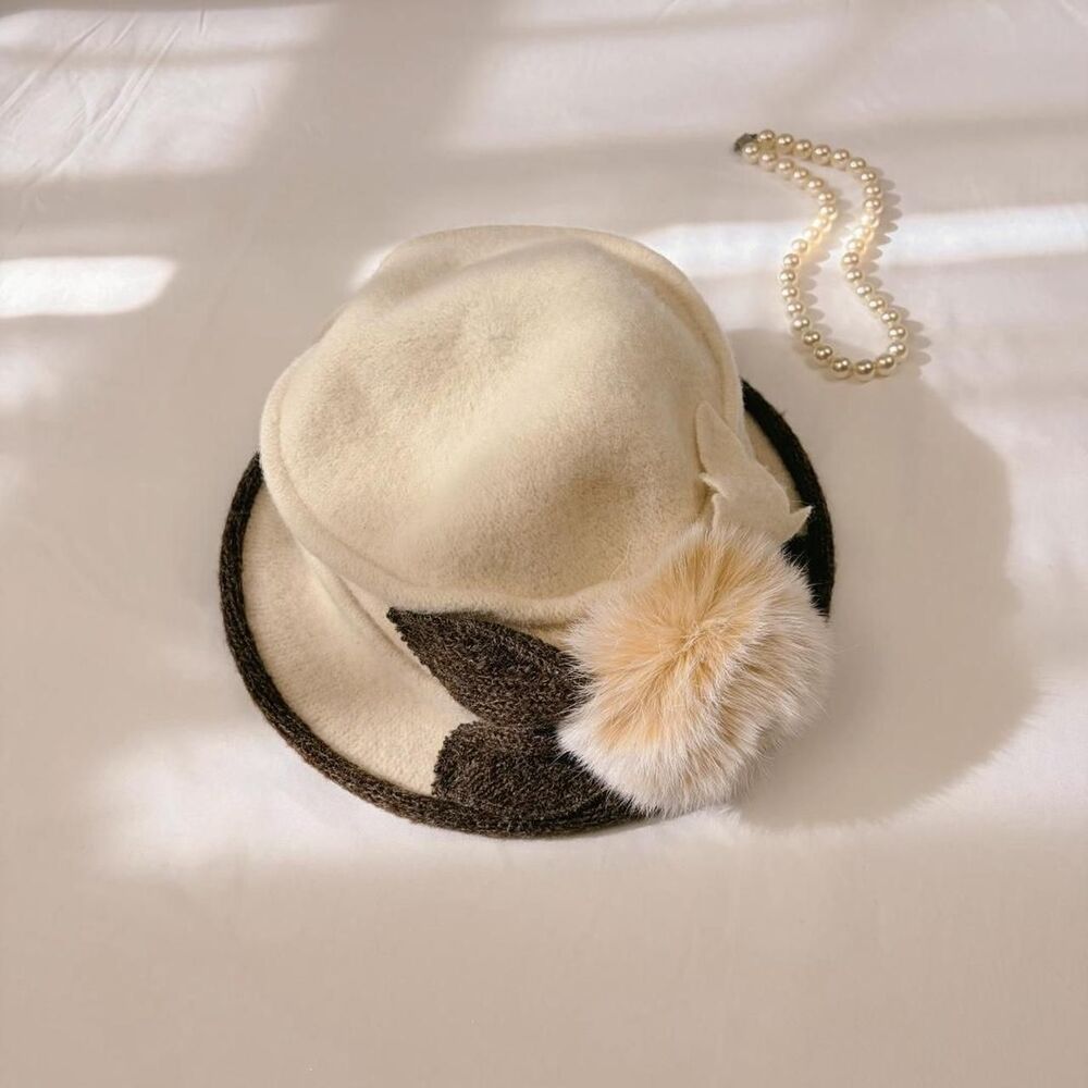 1920s style wool cloche in cream with a dark knit brim & genuine bunny fur pom
